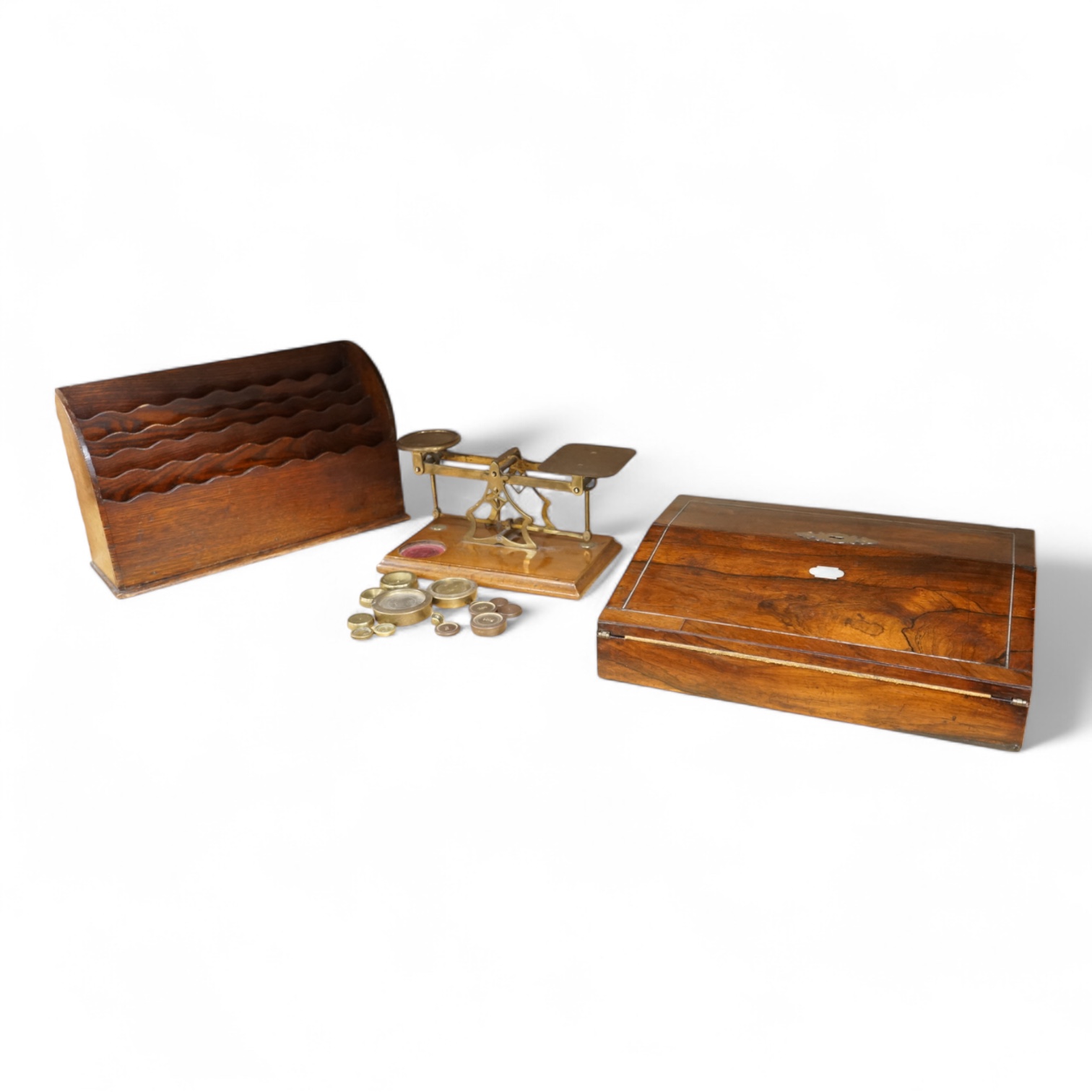 A tooled leather writing slope, a letter rack and postage scales, largest 37cm wide